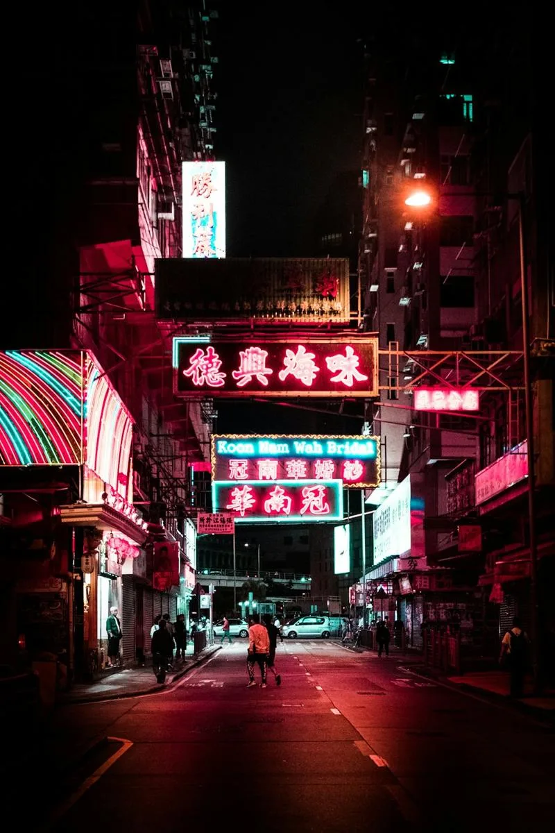 A side street lit pink and red