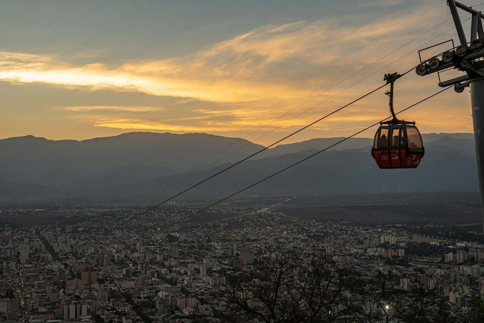 A gondola cabin over the city at sunset