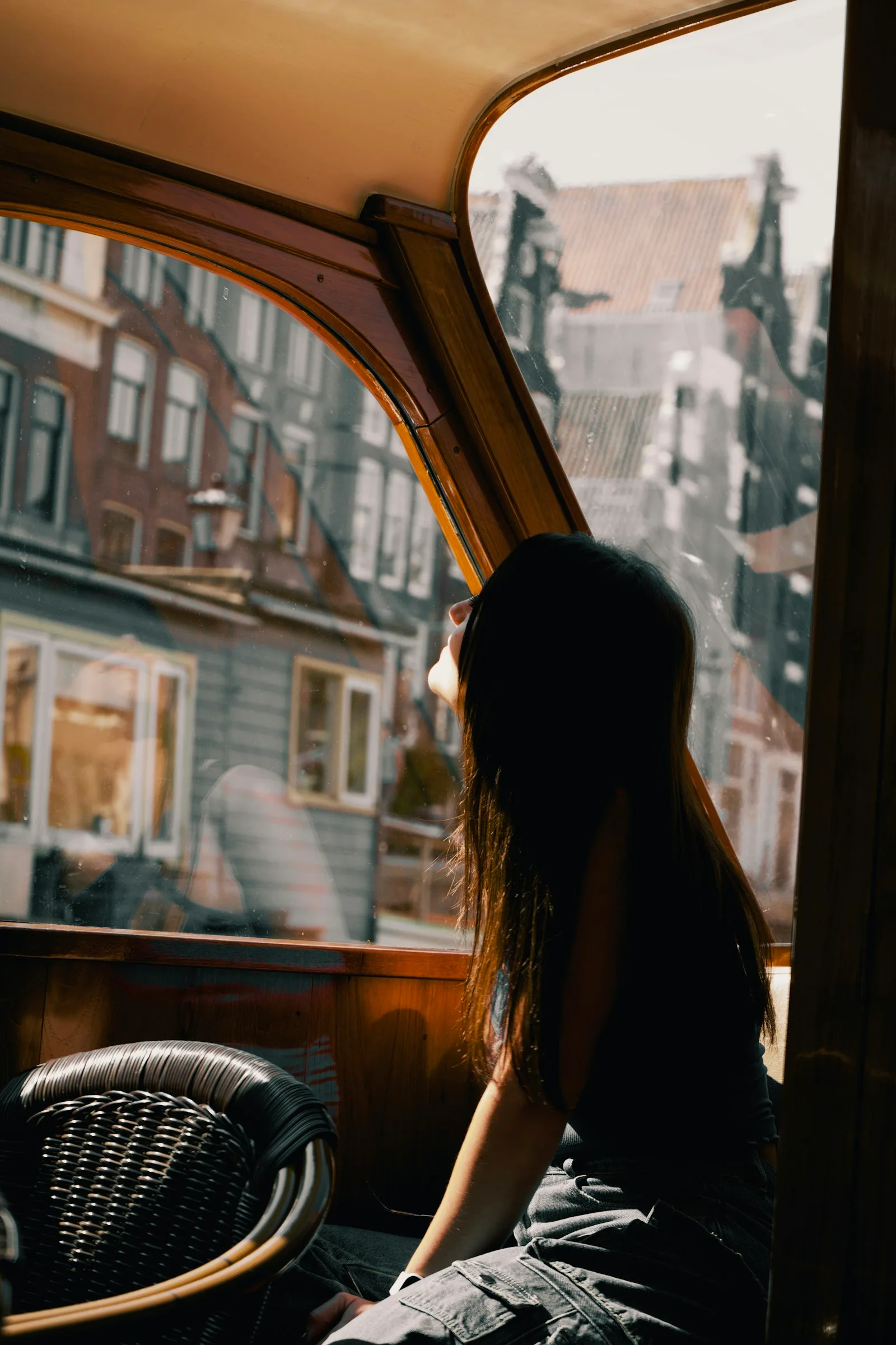 A woman looking out of a window on the way up